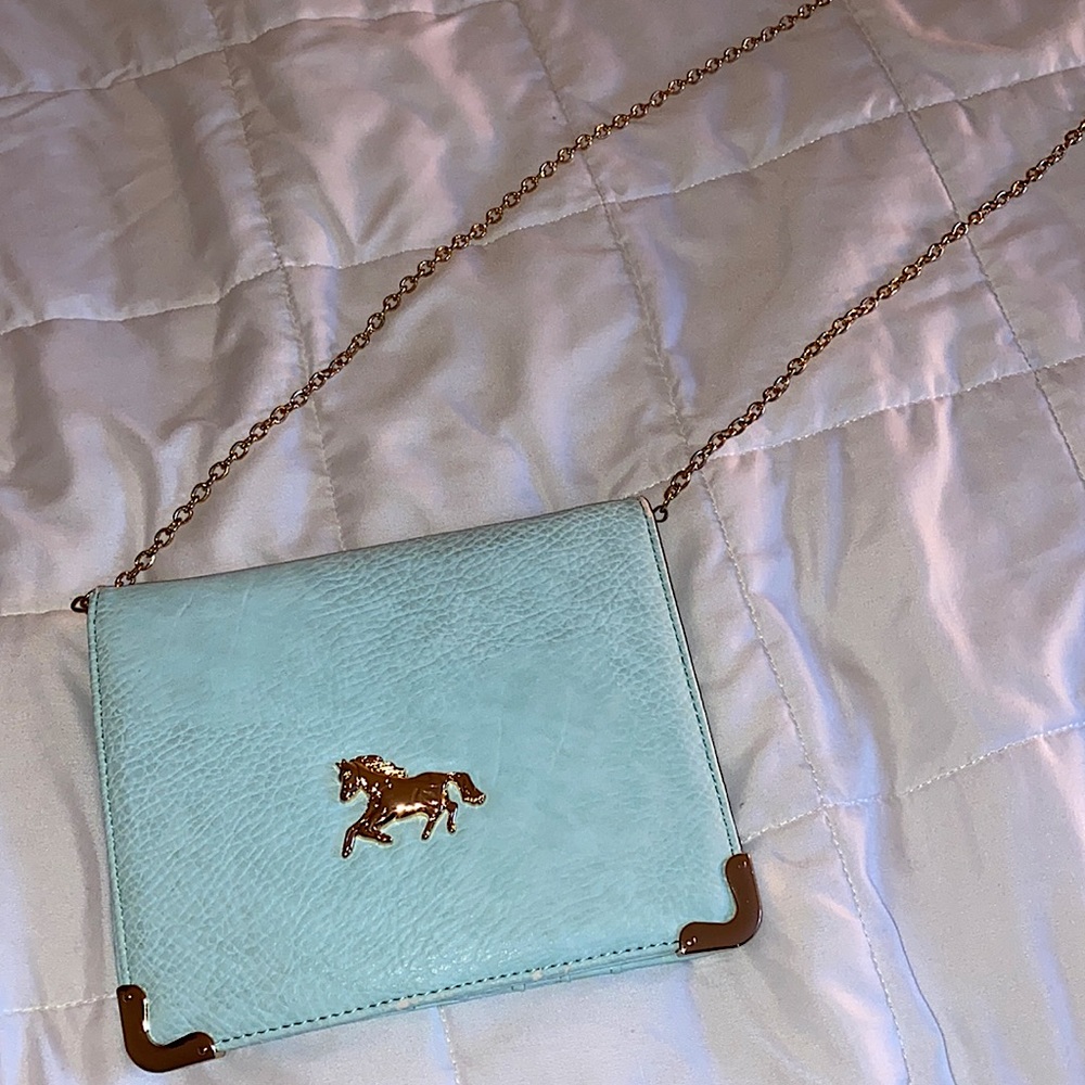 Light teal wallet/clutch. Faux leather, 7 card slots, 1 zipper slot + 5 pockets